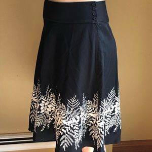 Black skirt with embroidered design.